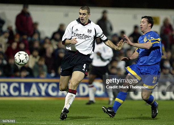 Robbie Fowler of Leeds tries to tackle Andy Melville of Fulham during the FA Barclaycard Premiership match between Fulham and Leeds United at Loftus...