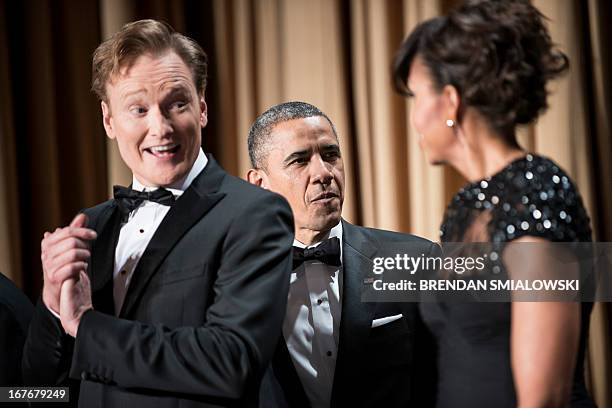 Comedian Conan O'Brien smiles as US President Barack Obama and US first lady Michelle Obama arrive for the White House Correspondents’ Association...