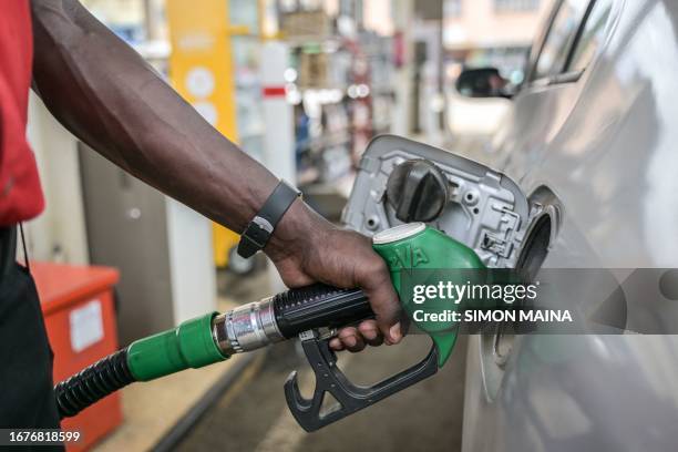 Pump attendant pumps fuel into a car at a gas station in Nairobi, on September 19, 2023. The price of petrol in Kenya hit a record high on September...