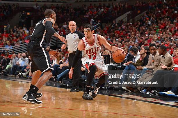 Kirk Hinrich of the Chicago Bulls dribbles the ball against C.J. Watson of the Brooklyn Nets in Game Four of the Eastern Conference Quarterfinals...