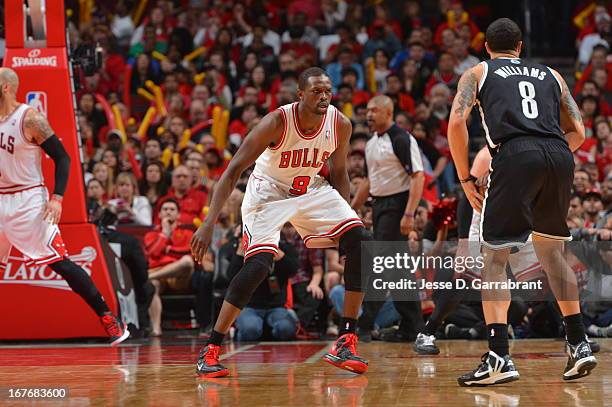 Deron Williams of the Brooklyn Nets looks to pass the ball against Luol Deng of the Chicago Bulls in Game Four of the Eastern Conference...