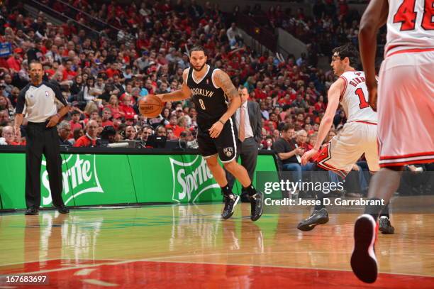 Deron Williams of the Brooklyn Nets dribbles to the basket against the Chicago Bulls in Game Four of the Eastern Conference Quarterfinals during the...