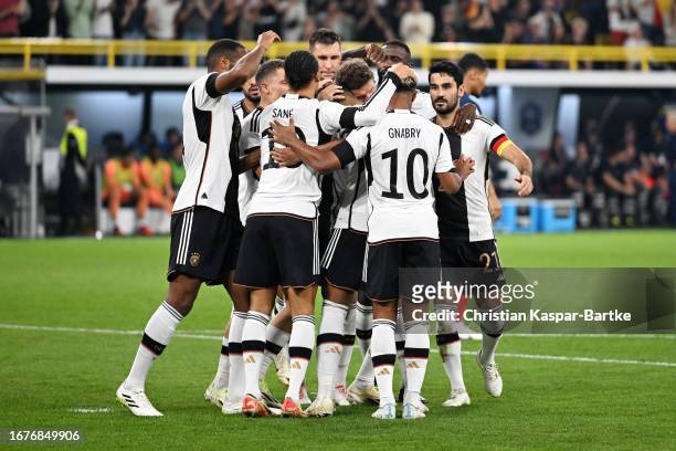 Thomas Mueller of Germany celebrates with teammates after scoring the team's first goal during the International Friendly match between Germany and...