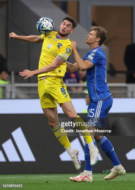 Roman Yaremchuk of Ukraine attempts to control an aerial ball under pressure from Giorgio Scalvini of Italy during the UEFA EURO 2024 European...