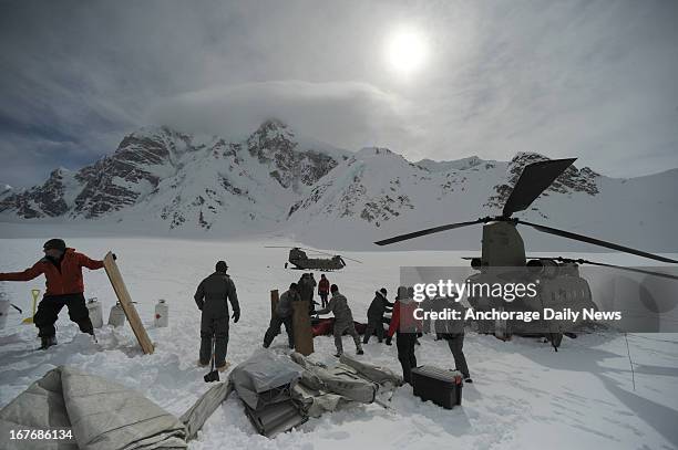 Members of B Company 1st Battalion 52 Aviation Regiment unload a CH47 Chinook Helicopter from the Talkeetna, Alaska, airport at the Denali base camp...