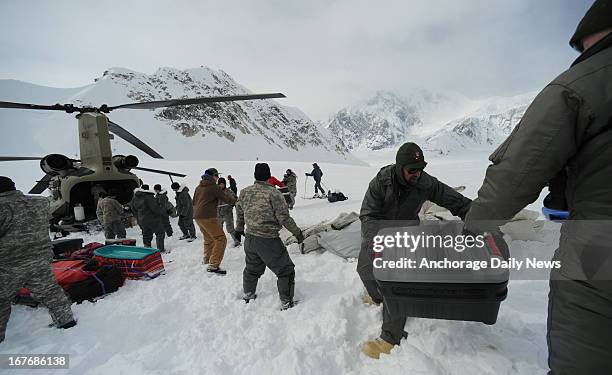 Members of B Company 1st Battalion 52 Aviation Regiment unload a CH47 Chinook Helicopter from the Talkeetna, Alaska, airport at the Denali base camp...