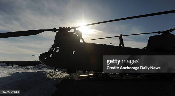 Members of B Company 1st Battalion 52 Aviation Regiment do preflight checks on a CH47 Chinook Helicopter at the Talkeetna, Alaska, airport on Friday,...