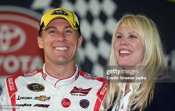 Kevin Harvick, driver of the Bell Helicopter Chevrolet, celebrates with wife DeLana Harvick in Victory Lane after winning the NASCAR Sprint Cup...