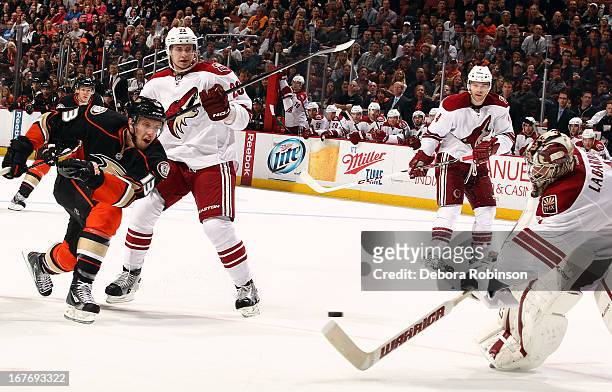 Nick Bonino of the Anaheim Ducks shoots and Jason LaBarbera of the Phoenix Coyotes attempts to stop the puck with his stick during the game on April...