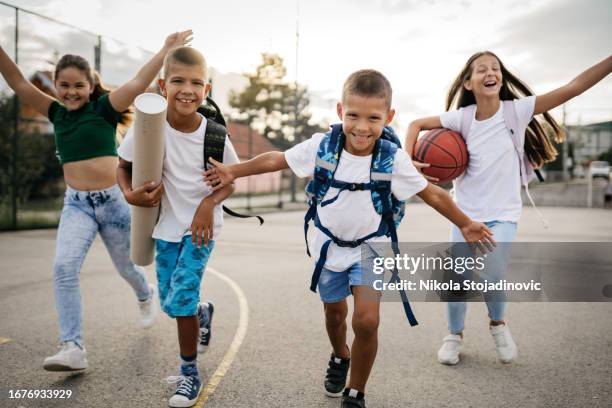 happy students coming to school - elementary school building outside stock pictures, royalty-free photos & images