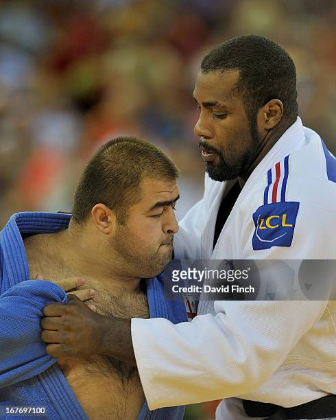 Olympic and World champion, Teddy Riner of France competes with Adam Okruashvili of Georgia on his way to winning the o100kgs title during the...
