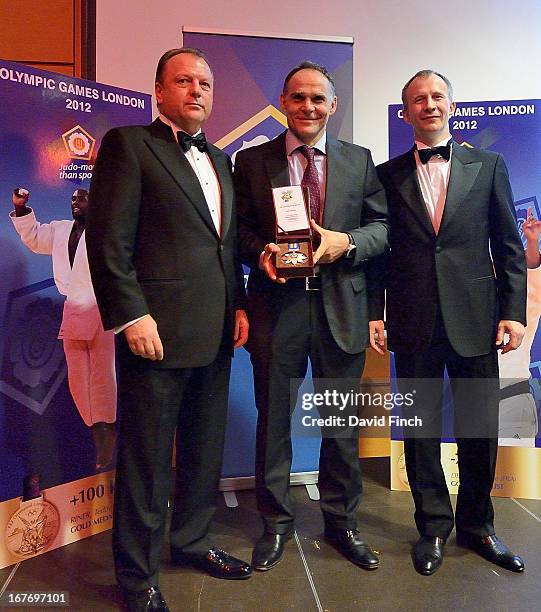 Former Olympic champion, Ezio Gamba of Italy receives an award for the best European coach presented by Sergey Soloveychik and Marius Vizer at the...