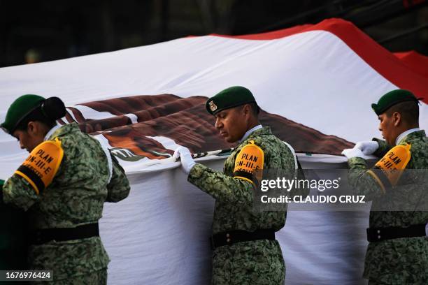 Army soldiers take part in the hoisting of the national flag ceremony in memory of the victims of the 1985 and 2017 earthquakes on the anniversary of...