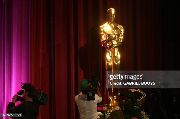Reporters shoot the Oscar statue during the announcement of the 80th Academy Awards nominations, 22 January 2008 in Beverly Hills, California. The...