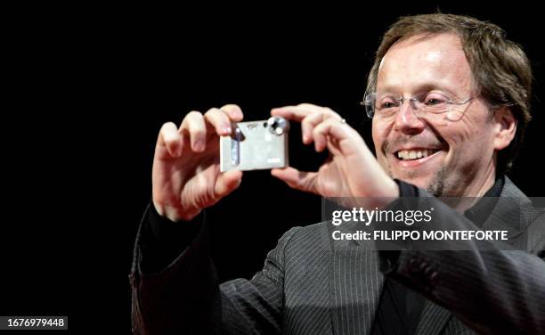 Director Fernando Meirelles takes a snap at his arrival at the premiere of his movie 'The Constant Gardener' at the 62nd edition of Venice...