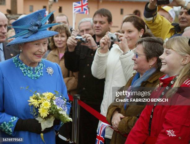 Britain's Queen Elizabeth II walks past well wishers during her visit to Krongut Bornstedt, a former Prussian royal estate in Potsdam, south of...