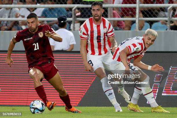 Alexander Gonzalez of Venezuela competes for the ball with Gabriel Avalos and Ramon Sosa of Paraguay during a FIFA World Cup 2026 Qualifier match...
