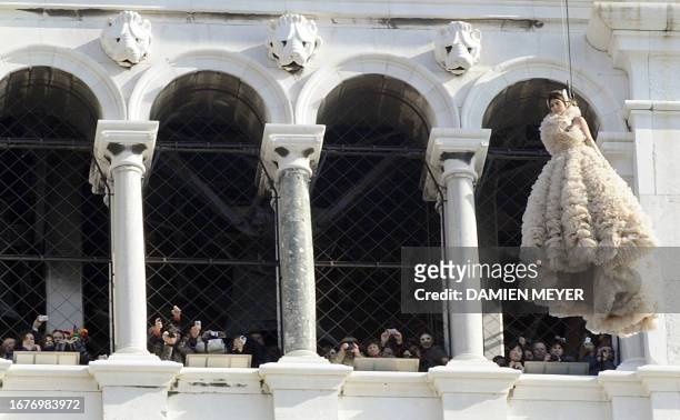 Spectators take pictures of Bianca Brandolini d'Adda as she performs the "Angel Flight" from the Campanile on San Marco square in Venice on February...