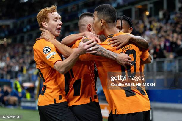 Shakhtar Donetsk's Venezuelan forward Kevin Kelsy celebrates scoring the 1-1 goal with his team-mates during the UEFA Champions League Group H...