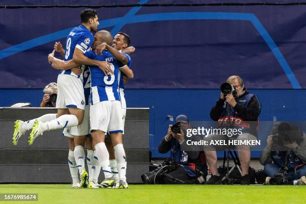 Porto's Brazilian midfielder Wenderson Galeno celebrates scoring the opening goal with his teammates during the UEFA Champions League Group H...