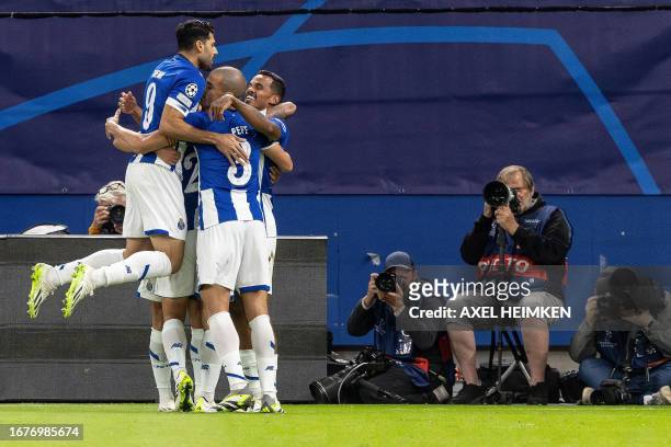 Porto's Brazilian midfielder Wenderson Galeno celebrates scoring the opening goal with his teammates during the UEFA Champions League Group H...