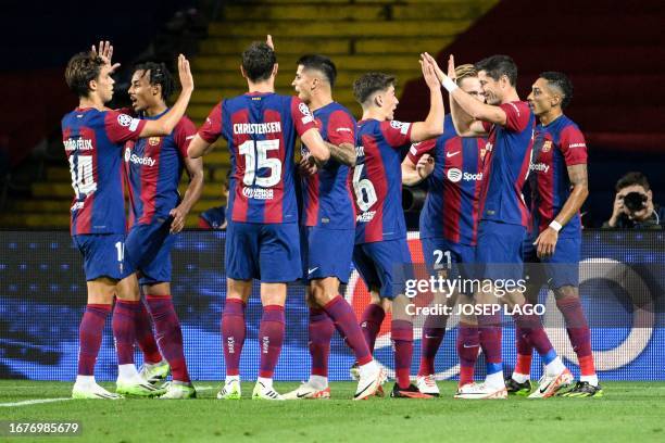 Barcelona's Polish forward Robert Lewandowski celebrates with teammates after scoring his team's second goal during the UEFA Champions League 1st...