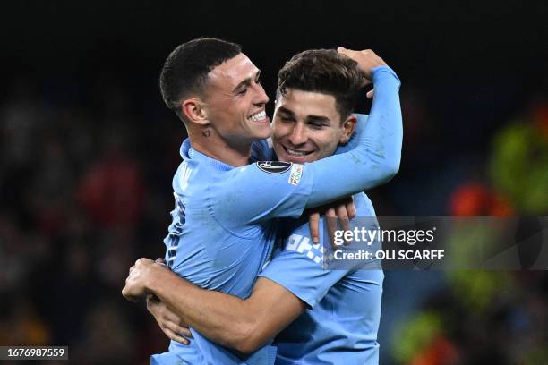 Manchester City's Argentinian striker Julian Alvarez celebrates with Manchester City's English midfielder Phil Foden after scoring his team second...