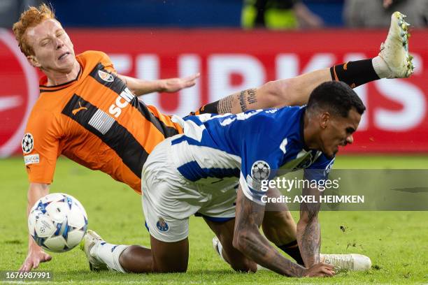 Shakhtar Donetsk's Ukrainian defender Yukhym Konoplia and FC Porto's Brazilian midfielder Wenderson Galeno vie for the ball during the UEFA Champions...