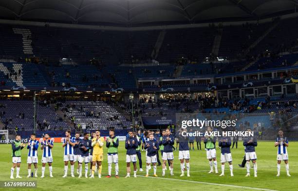 Porto's players applaud after the UEFA Champions League Group H football match Shakhtar Donetsk v FC Porto at the Volkspark Stadium in Hamburg,...