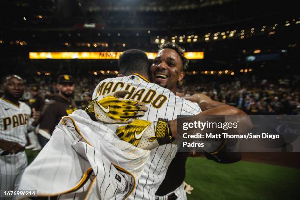 Xander Bogaerts hugs Manny Machado of the San Diego Padres after hitting a walk-off home run in the ninth inning against the Colorado Rockies on...