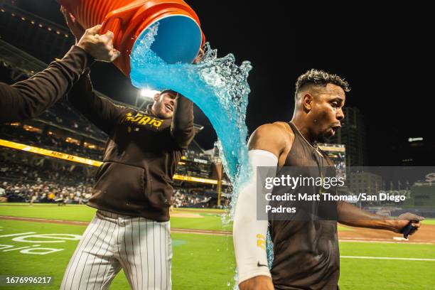 Xander Bogaerts of the San Diego Padres is doused in Gatorade during the post-game interview after hitting a walk-off home run against the Colorado...