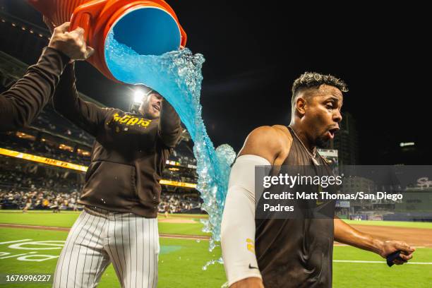 Xander Bogaerts of the San Diego Padres is doused in Gatorade during the post-game interview after hitting a walk-off home run against the Colorado...