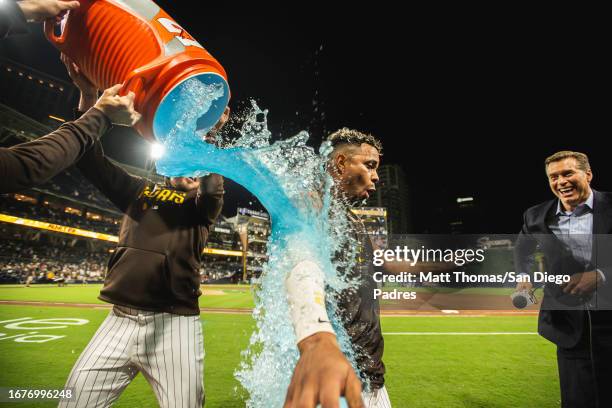 Xander Bogaerts of the San Diego Padres is doused in Gatorade during the post-game interview after hitting a walk-off home run against the Colorado...