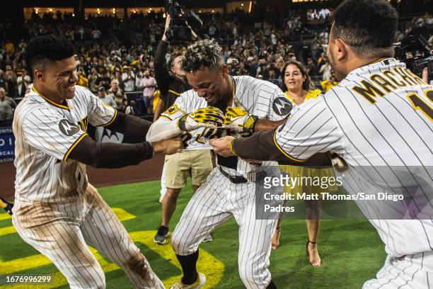Juan Soto, Xander Bogaerts and Manny Machado of the San Diego Padres celebrate after Bogaerts' walk-off home run against the Colorado Rockies on...