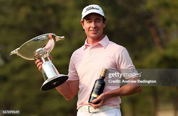 Brett Rumford of Australia poses with the trophy and a bottle of Ballantine's whisky after winning the Ballantine's Championship at Blackstone Golf...