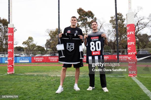 Mason Cox of the Collingwood Magpies and Pierre-Luc Dubois of the Los Angeles Kings exchange jerseys on the field at the AIA Centre Oval as part of...