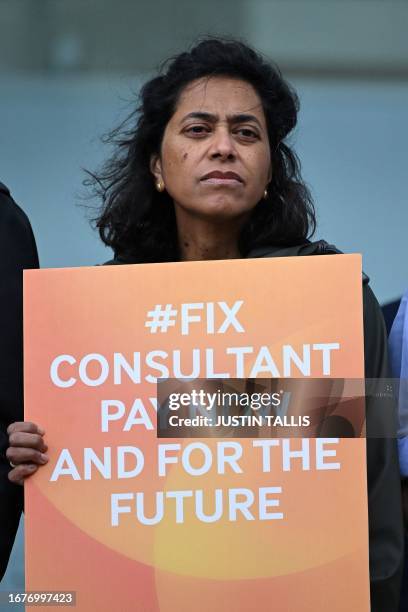 National Health Service worker holds a placard at a picket line outside University College Hospital in central London on September 20, 2023 as...