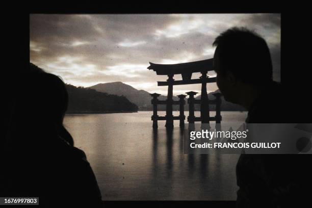 People look at a photograph of the Itsukushima Tori sanctuary in Miyagima circa October 1926 at the Albert Kahn museum show "Japanese Cliches" on...