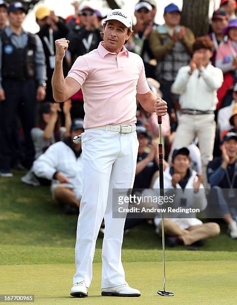 Brett Rumford of Australia celebrates after holing an eagle putt at the first play-off hole to win the play-off and the Ballantine's Championship at...
