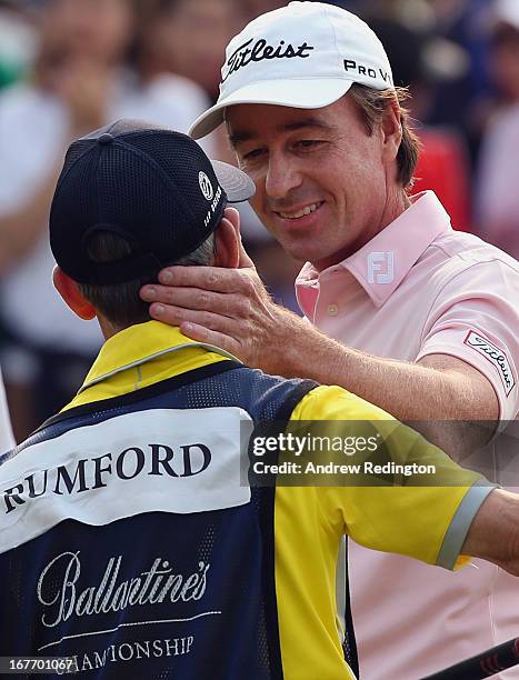 Brett Rumford of Australia celebrates with his caddie after holing an eagle putt at the first play-off hole to win the play-off and the Ballantine's...