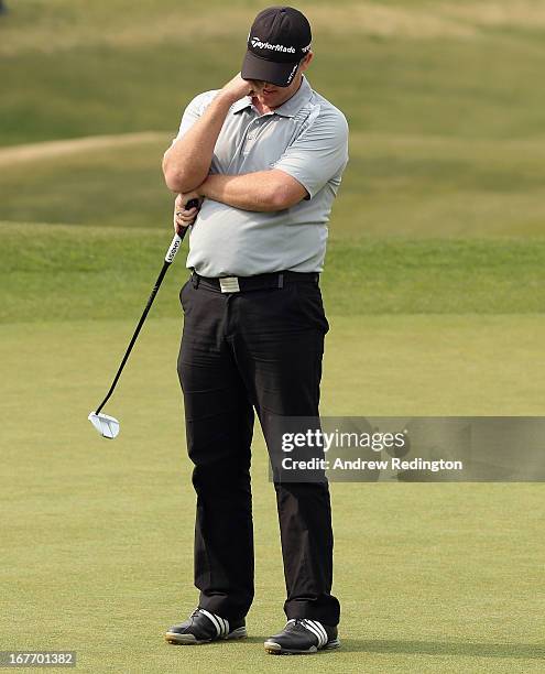 Marcus Fraser of Australia reacsts after missing a birdiie putt on the 18th hole during the final round of the Ballantine's Championship at...