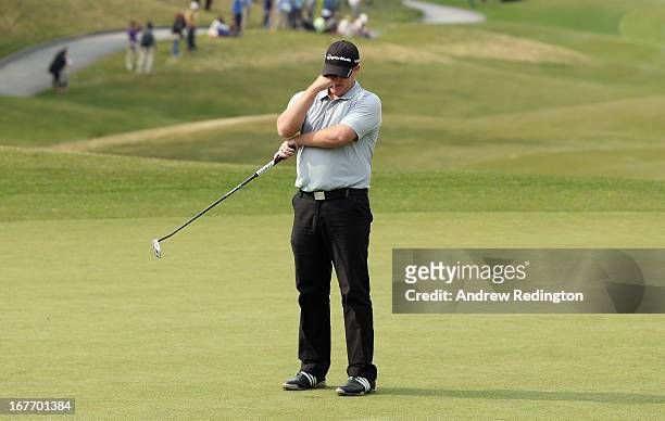 Marcus Fraser of Australia reacsts after missing a birdiie putt on the 18th hole during the final round of the Ballantine's Championship at...