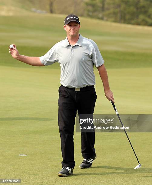 Marcus Fraser of Australia waves to the crowd on the 18th hole during the final round of the Ballantine's Championship at Blackstone Golf Club on...