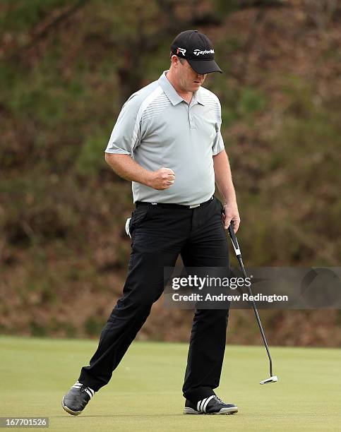 Marcus Fraser of Australia celebrates after holing a par putt in the 17th hole during the final round of the Ballantine's Championship at Blackstone...