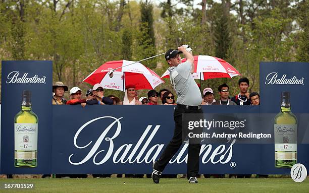 Marcus Fraser of Australia hits his tee-shot on the 17th hole during the final round of the Ballantine's Championship at Blackstone Golf Club on...