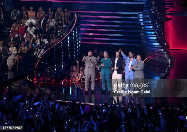 Joey Fatone, Lance Bass, Justin Timberlake, JC Chasez and Chris Kirkpatrick of NSYNC speak onstage during the 2023 MTV Video Music Awards at...