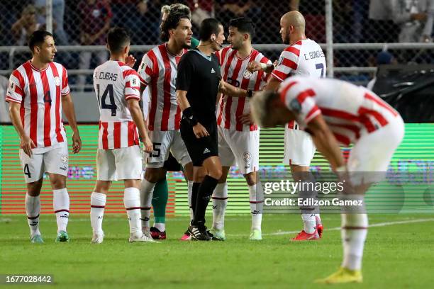 Gustavo Gomez of Paraguay and his teammates react to referee Andres Jose Rojas during a FIFA World Cup 2026 Qualifier match between Venezuela and...