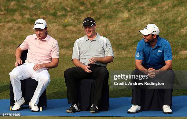 Brett Rumford and Marcus Fraser share a joke with Peter Whiteford of Scotland during the prize-giving for the Ballantine's Championship at Blackstone...