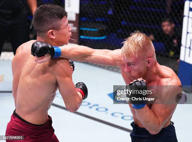 Kasey Tanner punches Jean Matsumoto of Brazil in a bantamweight fight during Dana White's Contender Series season seven, week six at UFC APEX on...