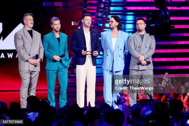 Joey Fatone, Lance Bass, Justin Timberlake, JC Chasez, and Chris Kirkpatrick of *NSYNC speak onstage the 2023 MTV Video Music Awards at Prudential...